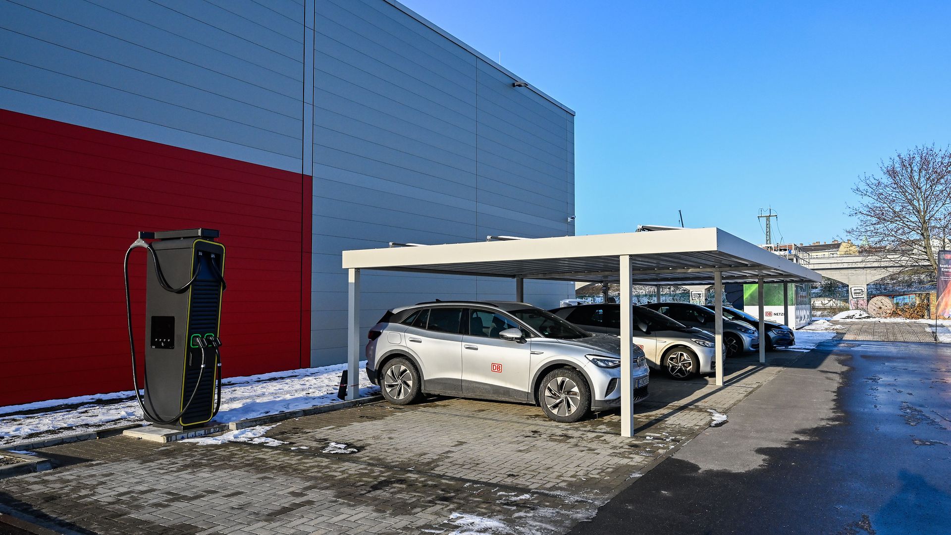 Carport with 4 cars and a charging station